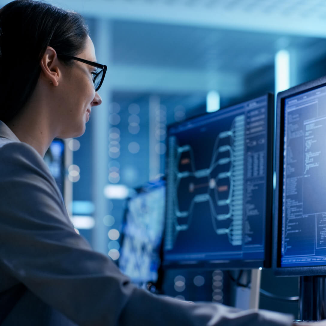  woman wearing glasses working on monitor