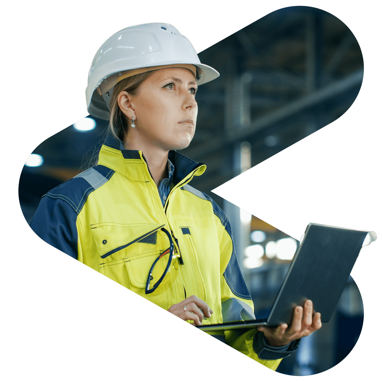 woman wearing a yellow jacket and hard hat while holding a laptop