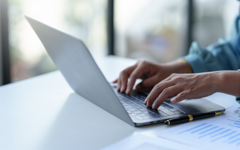 Someone typing on a laptop